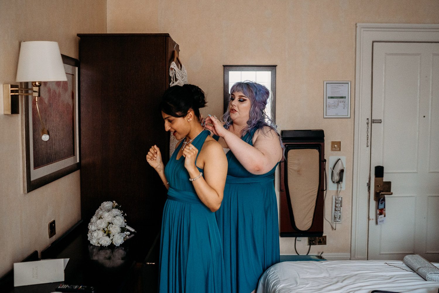 alternative bridesmaids helping with dresses