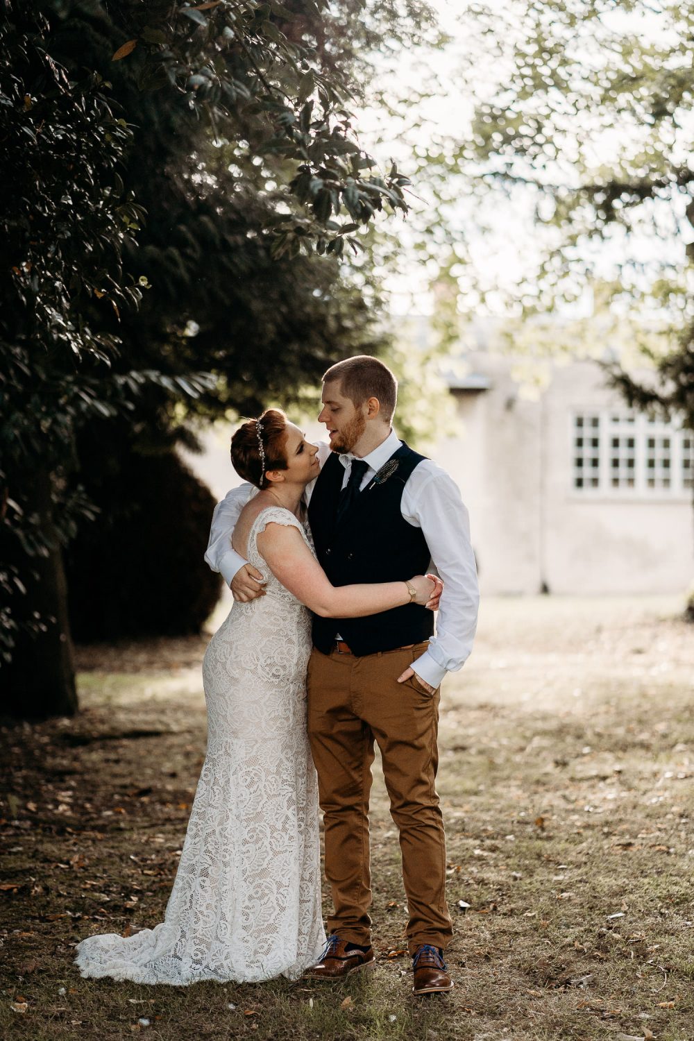 bride and groom cuddling each other at sunset