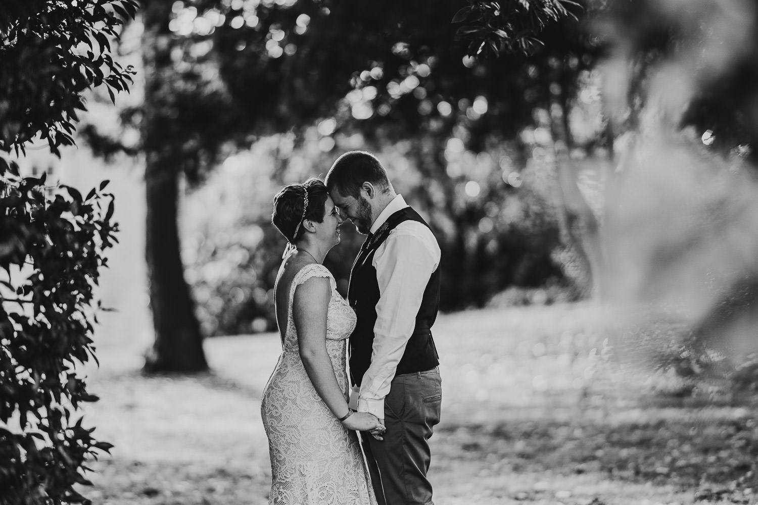 groom and bride laughing and holding hands