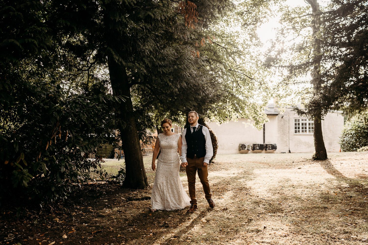 bride and groom walking outside of mercure elcot wedding venue