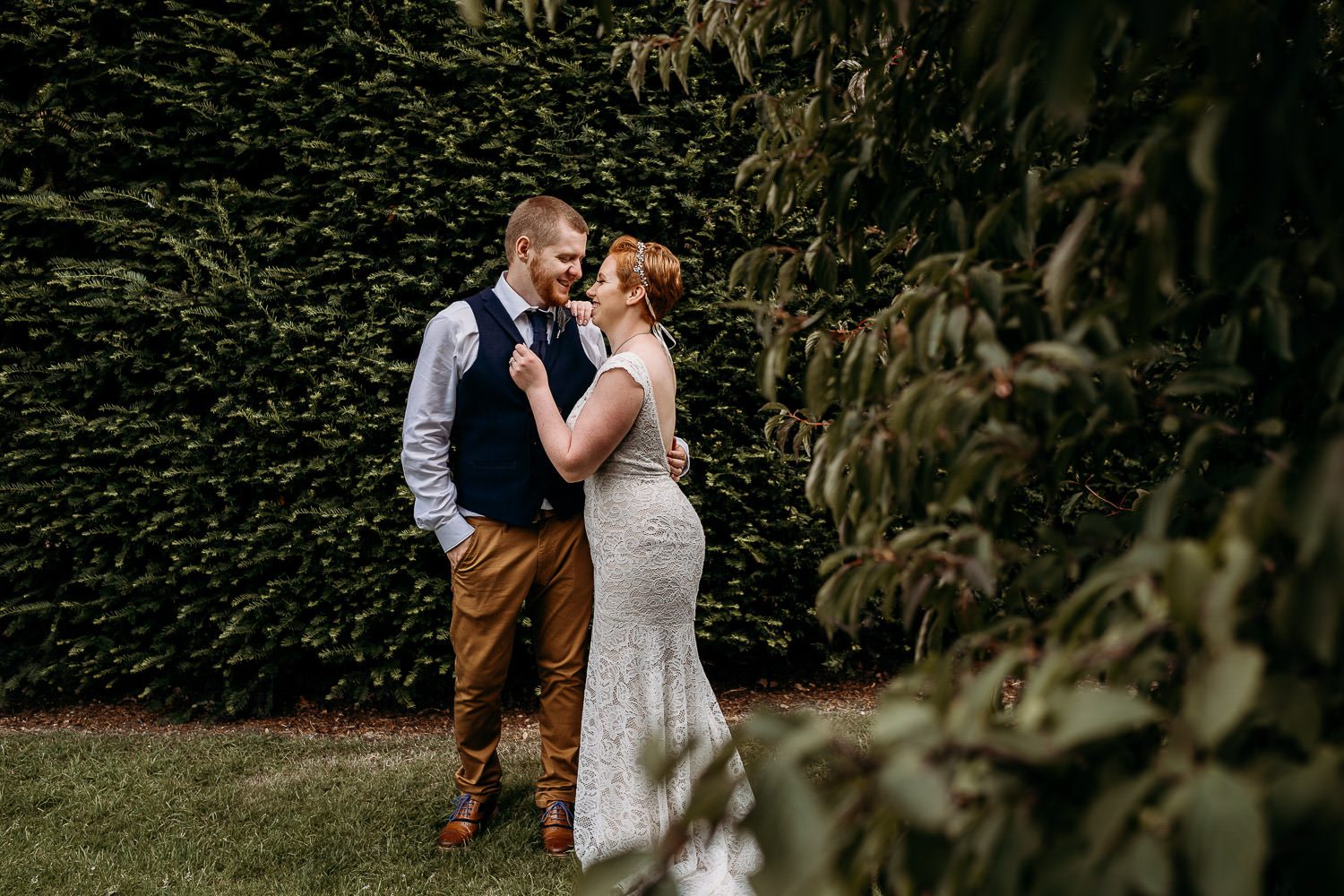 groom smiling at bride during couple portraits outside mercure newbury hotel