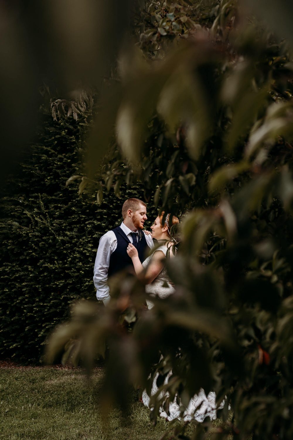 romantic bride and groom holding each other in gardens