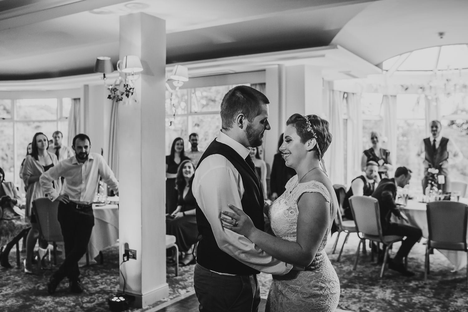 bride smiling up at groom during first wedding dance