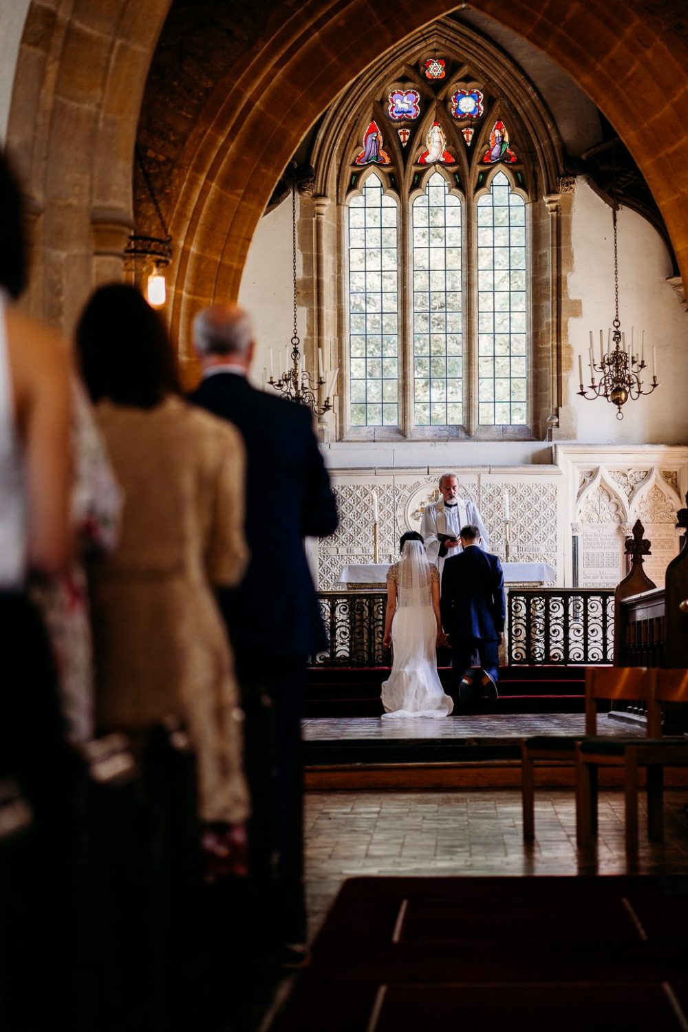 bride and groom kneeling at altar during somerset church wedding