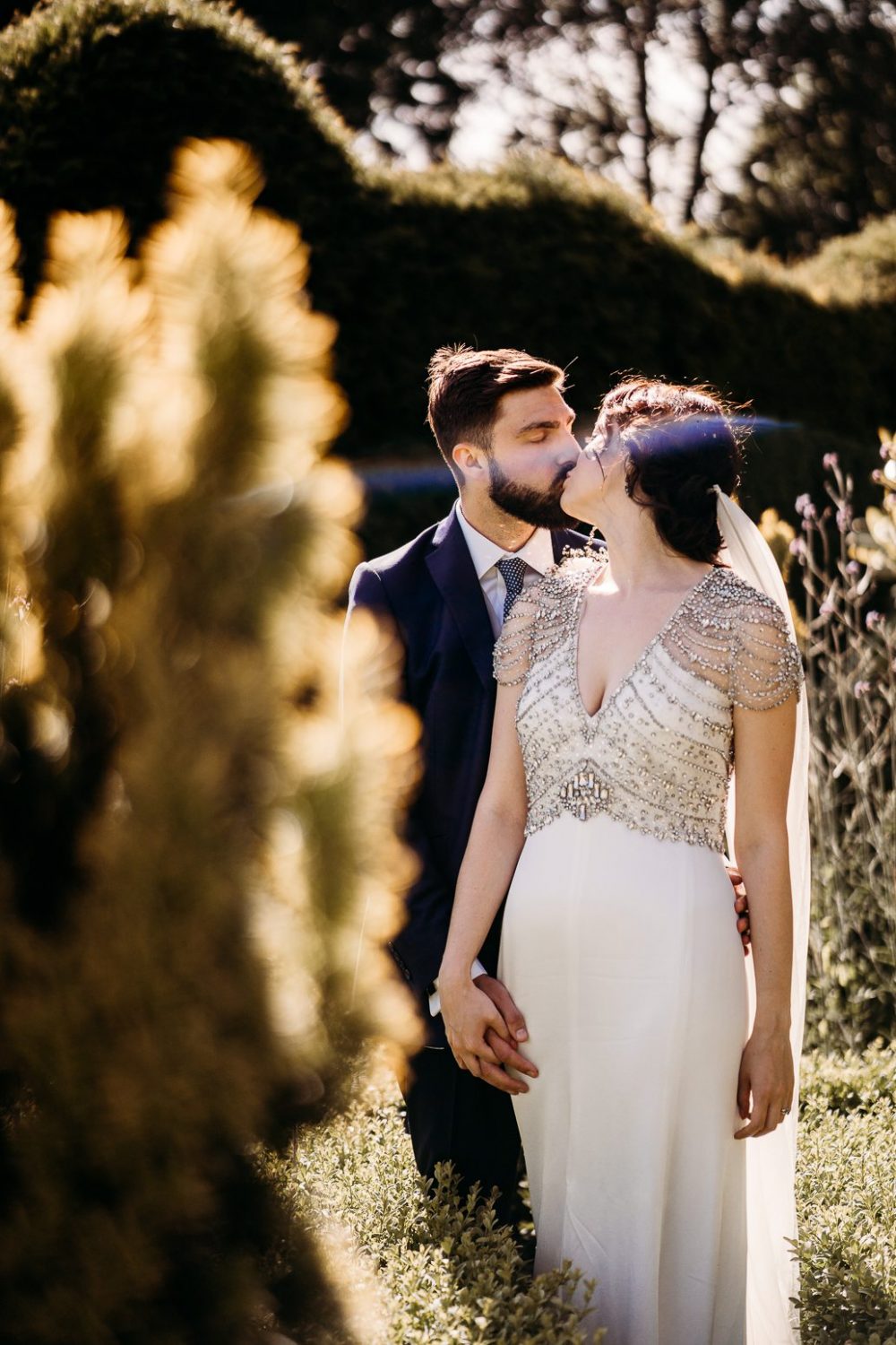bride and groom kissing outside manor farm tipi wedding