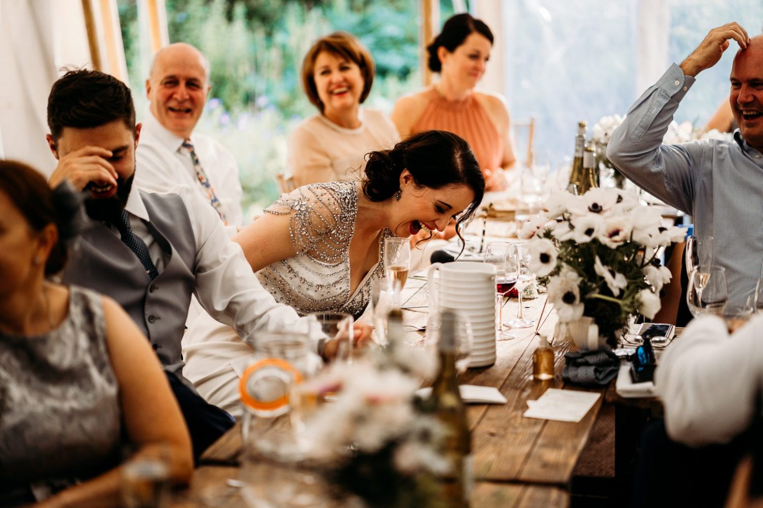 groom laughing during speeches at art deco style tipi wedding