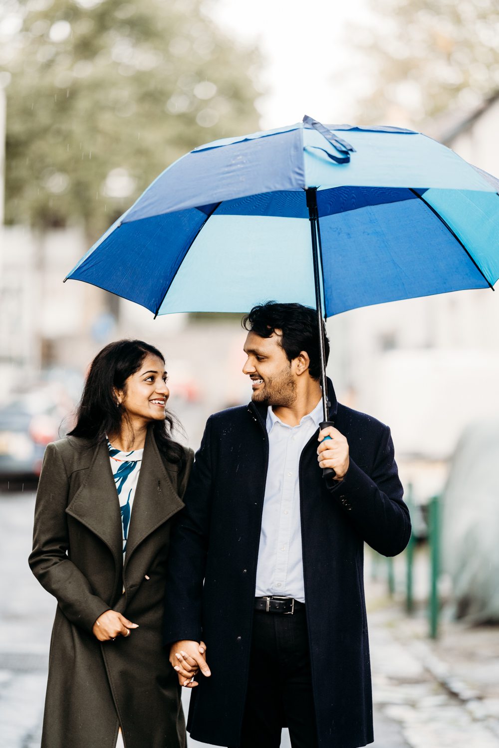 newly engaged couple walking in the rain in bristol