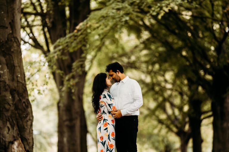 a couple embracing with a back ground of trees in bristol