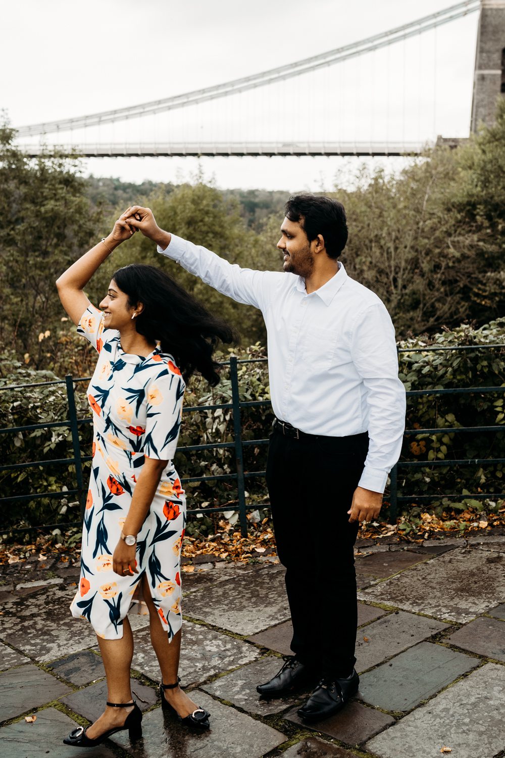 newly engaged couple dancing in the park