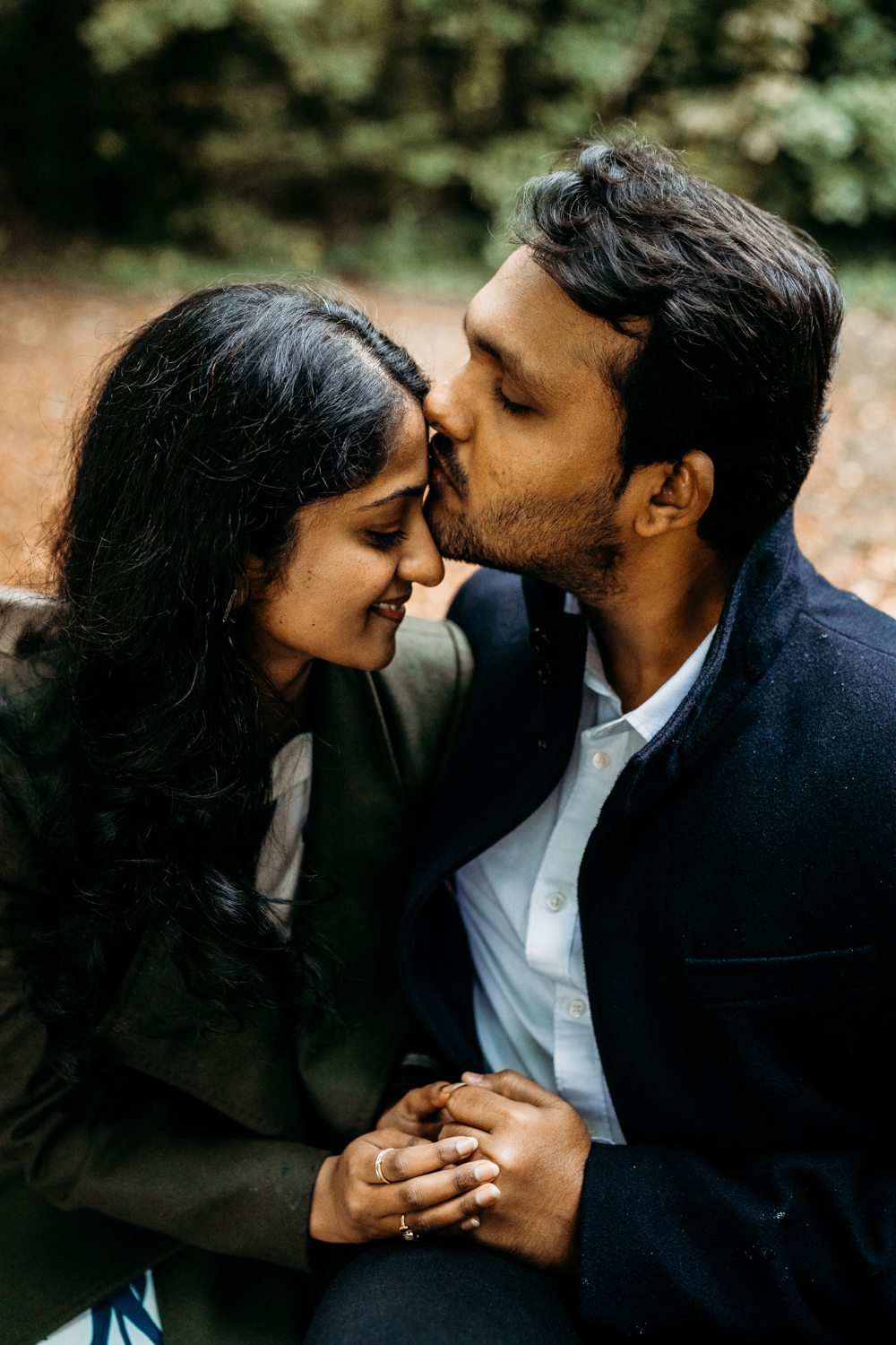 newly engaged couple sharing a kiss