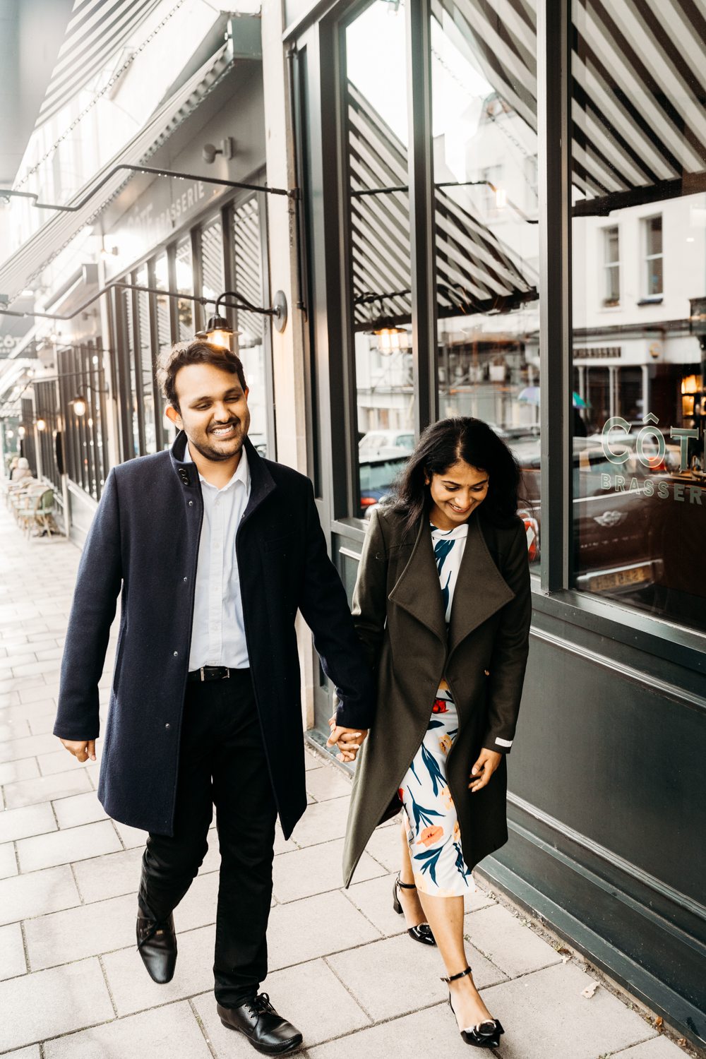 newly engaged couple laughing while walking in bristola