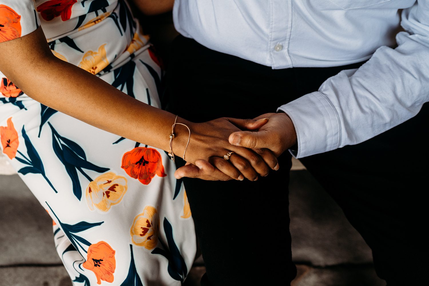bride to be shows her engagement ring while holding her future husbands hand